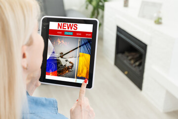 tablet news war and flag of russia and ukraine