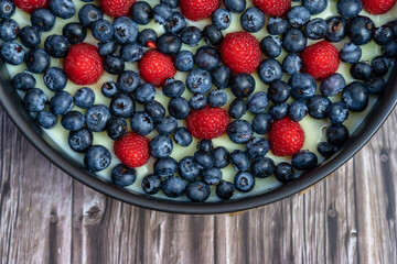 blueberries and raspberries on a cake