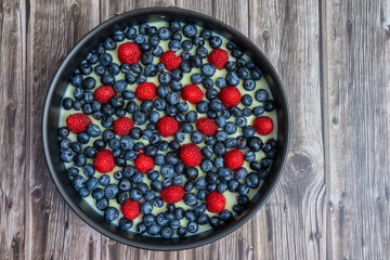 Raspberries and blueberries on the top of a cake
