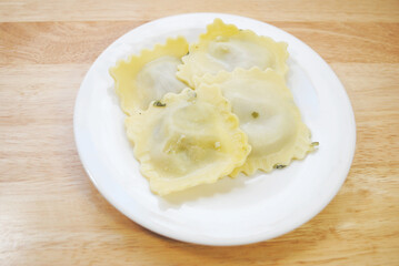 Four Appetizing Large Spinach Raviolis on a White Plate