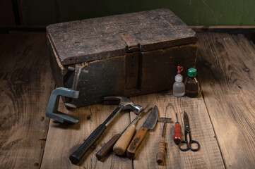 A set of old tools on the table. Various hand tools on the table. Vintage and low key.