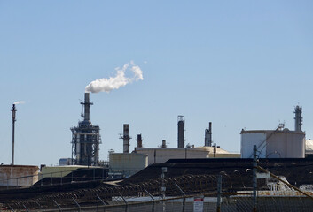 Fototapeta na wymiar oil refinery emitting air pollution from its chimney
