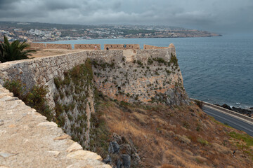 Stone wall of ancient Venetian fortress Fortezza on hill on seashore, Rethymnon, Greece © Igor