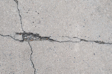 Macro shooting of big crack on light asphalt road