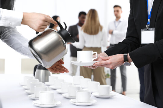 Waitress Pouring Hot Drink During Coffee Break, Closeup