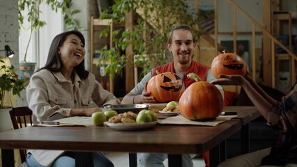 Fototapeta premium Young ladies exchange their handmade pumpkins and talk