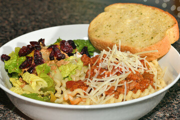Pasta and salad with garlic bread