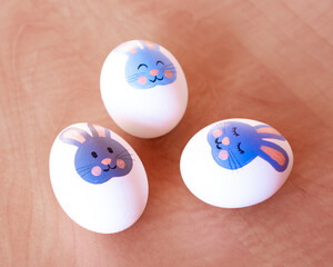 Easter eggs with a bunny pattern. Drawing with paints on a white egg