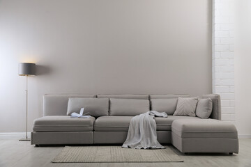 Large grey sofa in living room. Interior design