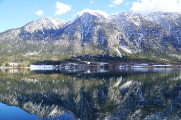 Mountain lanscape with lake and reflection in the water. Traunsee Lake in Austrian Alps in winter scenic view.