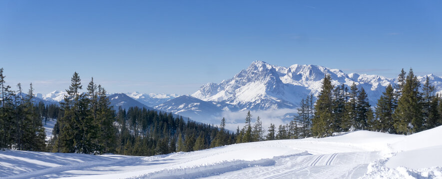Wide scenic mountain panorama during wintertime in Salzburg Alps, Austria, Europe. View from Rossbrand mountain on valley and surrounding countryside.