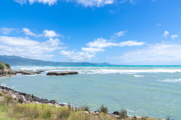 East Coast view of rough sea in windy conditions under blue sky with white clouds