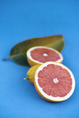 Cut grapefruit together with another citrus fruit.