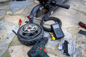 Electric scooter bicycle (Bike) wheel, tire repair. Inflating the tire with an electric air pump to find the puncture before patching with the repair kit.