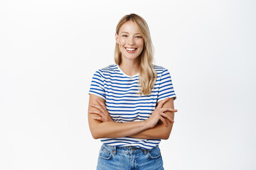 Beautiful happy girl laughing and smiling. Modern scandinavian woman posing against white background, looking happy, wearing summer clothes - 488422662