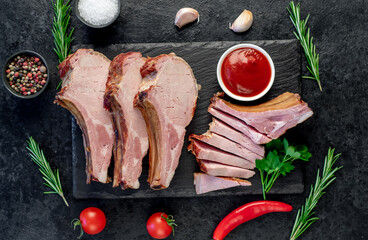 smoked pork steaks on the bone on a stone background