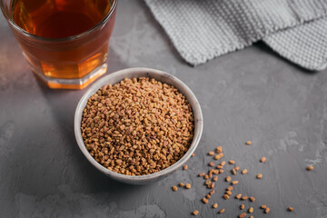 Bowl of fenugreek seeds and Egyptian fenugreek yellow tea or Methi Dana drink
