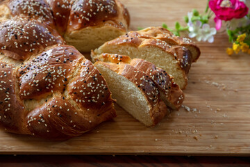 Easter sweet bread, greek tsoureki, brioche braid slice on table, close up view