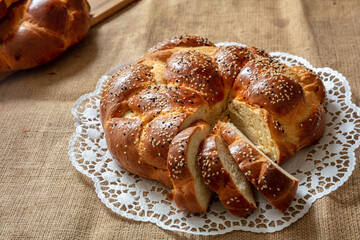 Easter sweet bread, greek tsoureki, brioche braid slice on table, close up view