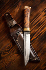 Knife on a wooden background