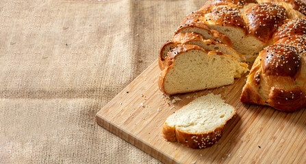 Easter sweet bread, greek tsoureki, brioche braid slice on table, close up view