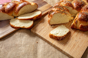 Easter sweet bread, greek tsoureki, brioche braid slice on table, close up view