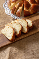 Easter sweet bread, greek tsoureki, brioche braid slice on table, close up view