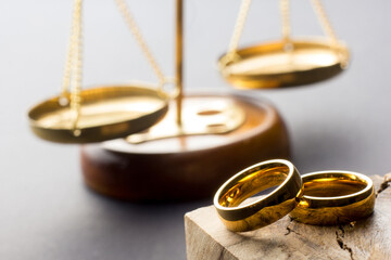 Divorce and separation concept. Two golden wedding rings, judge gavel. - 488425206