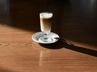 A cup of coffee on the table. A sunny day. A cup of coffee at the hotel.