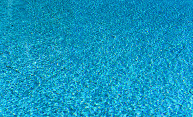 Fototapeta na wymiar Bright blue water in the pool. Summer background.