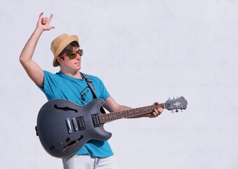 young man playing guitar in the street