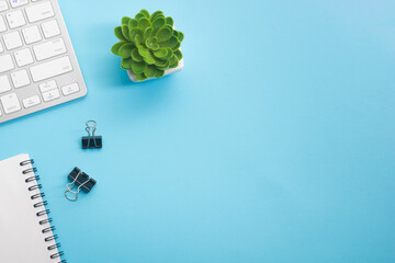 Blue desk office with laptop, smartphone and other work supplies with cup of coffee. Top view with...