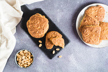 Fresh peanut cookies on a slate and in a plate on the table. Homemade pastries. Top view.