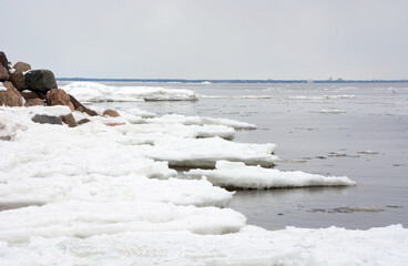 The frozen coast of the Gulf of Finland with a bizarre form of ice. Zelenogorsk, Russia, spring season, ice breaking period