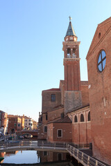 View of town Chioggia with canal Vena and church steeple of Chiesa della Santissima Trinita in Veneto, Italy