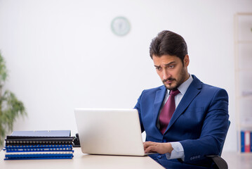 Young male employee working at workplace
