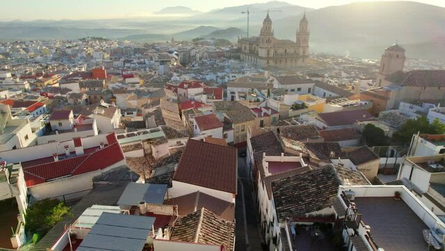 aerial view of the old historic Spanish town of Jaen, Andalusia, flying towards Jaen cathedral on a foggy sunny morning, touristic destination in Spain