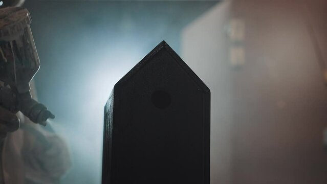 Close-up of an airbrush for tinting a wooden product in a carpentry workshop. Spray paint technology for wood