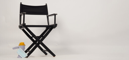 Black director chair and Clapper board or movie slate put on floor with megaphone on white background.