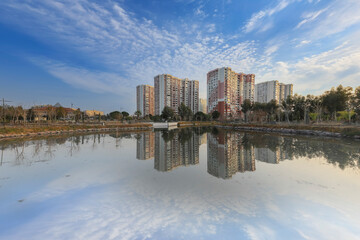 Obraz premium Karşıyaka- İzmir - Turkey - February 17, 2022 Karşıyaka Mavişehir Neighborhood houses and their reflections on the water