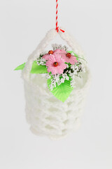 A flower pot in a knitted cover.