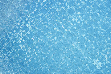 Jigsaw puzzle. Close-up of blank blue puzzle texture background