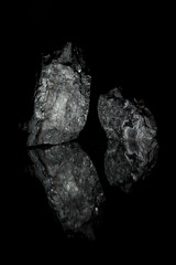 Relief stones with reflection. Photo for a desktop and home screen .  Coals are reflected in the glass surface. Stylish   photo for computer desktops and mobile home screens.
