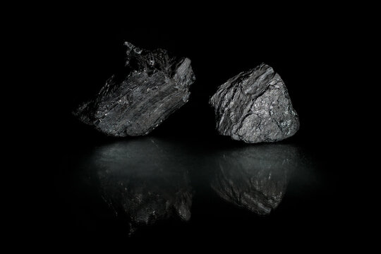 Coals are reflected in the glass surface. Stylish   photo for computer desktops and mobile home screens. Mineral carbon. A desktop picture. 