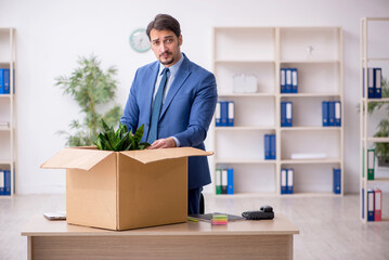 Young male employee in business relocation concept