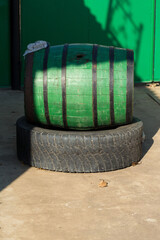 Image of an old oak wine barrel on the background of a rural courtyard.