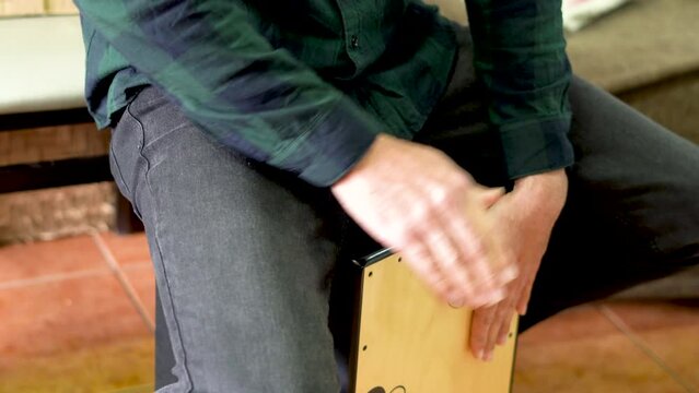 Male hands playing a cajon flamenco