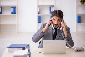 Young male employee working in the office