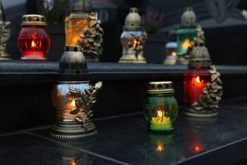 Grave lights on granite surface at cemetery