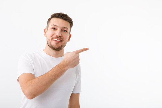 Portrait of a men on a white background pointing gesture to copyspace.